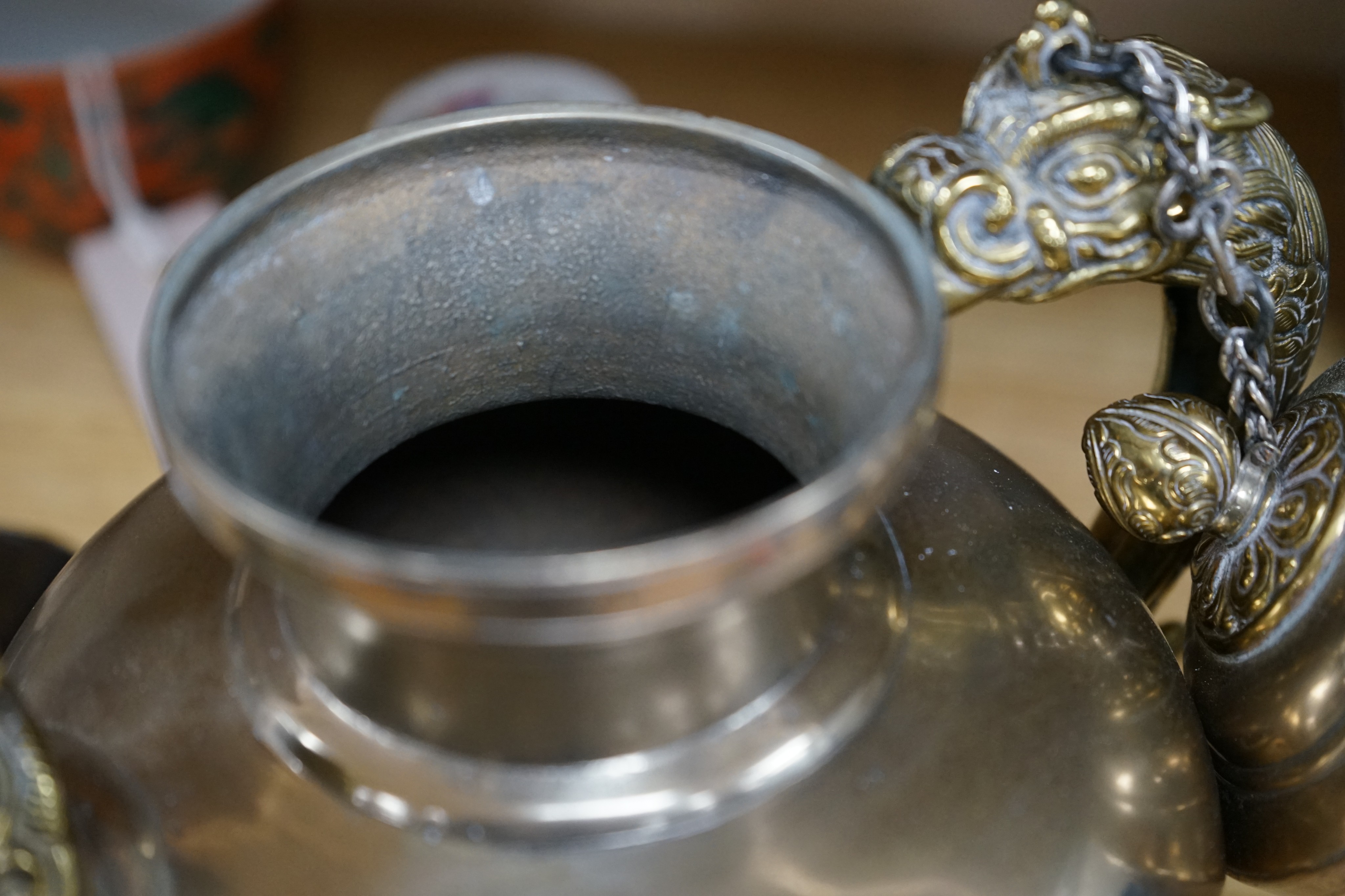 A late 19th/early 20th century Tibetan paktong, bronze and silver mounted teapot, 24cm